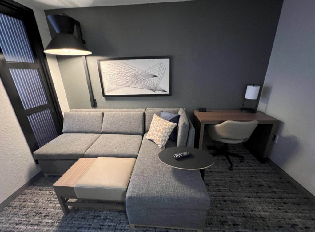 Living area with grey couch of hotel.